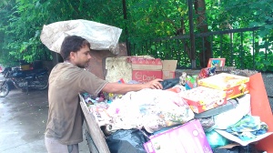 Beenu , a private garbage collector in Pitam Pura works bare hands and without face mask while collecting garbage.