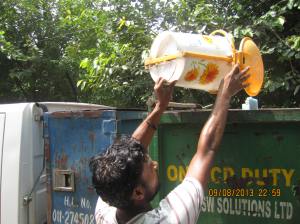 Krishnan dumps the trash in the Delhi MSW Solutions Ltd. van , without uniform.